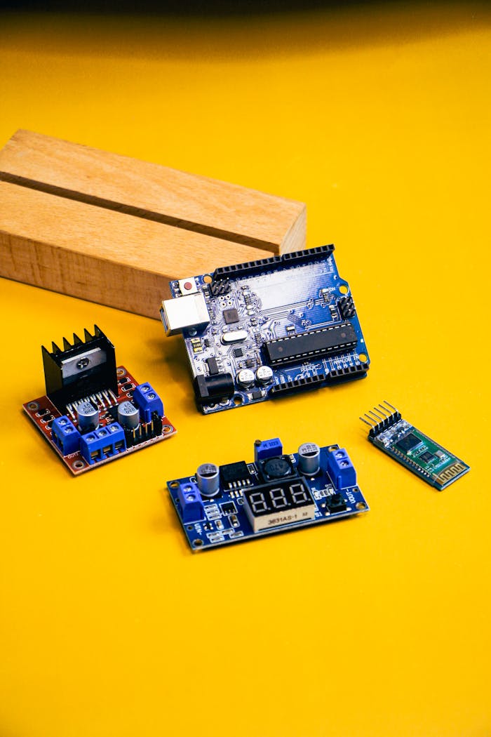 A detailed view of various robotics components set against a bold yellow backdrop, perfect for tech enthusiasts.